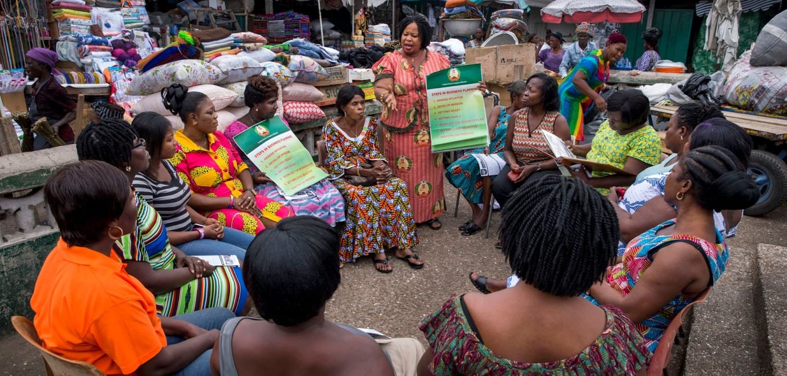 Background image showing people in an informal market